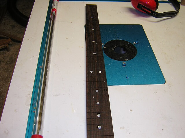Gluing the dot inlays in place.