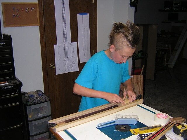 Tundra Boy sanding the radius into the fretboard.