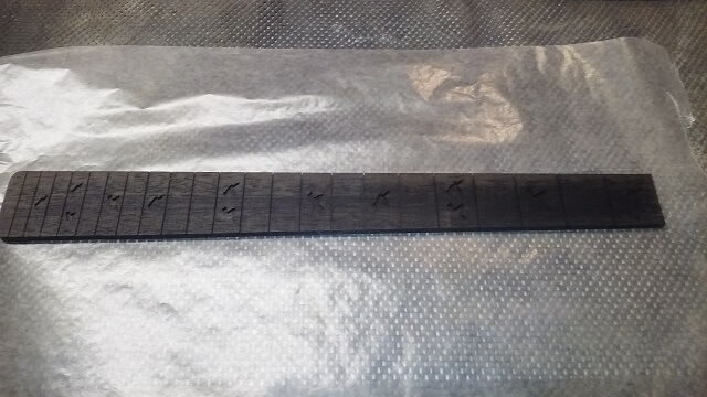 The fretboard ready for inlays.