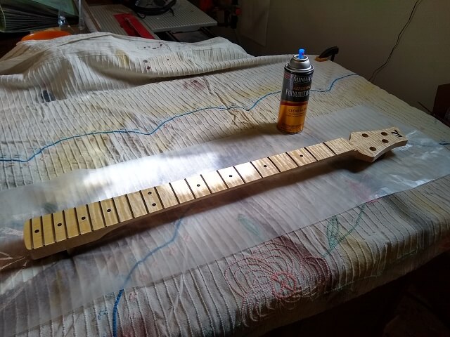 Applying polyurethane to the front of the neck.