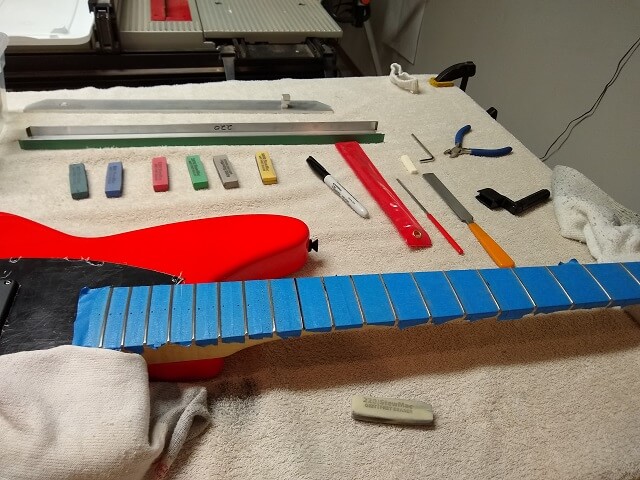 Crowning and polishing the frets.