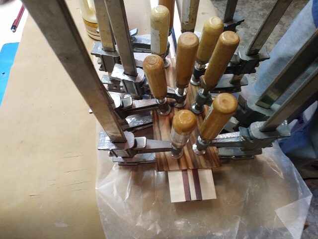 Gluing the zebrawood face to the front of the headstock.