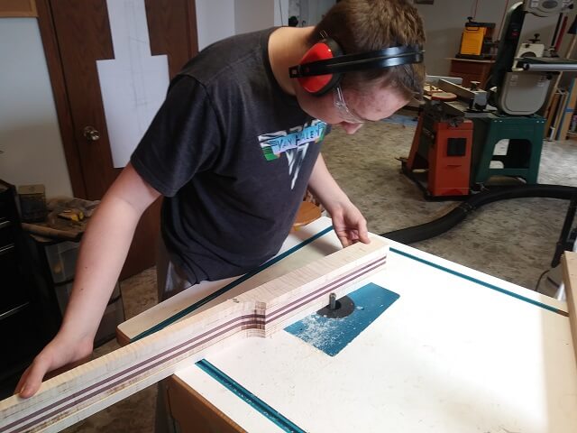 Cutting the scabbed on pieces of maple flush with the rest of the neck.