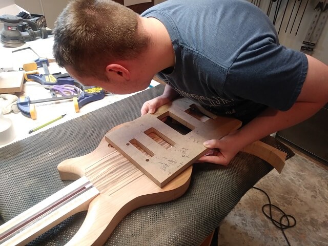 Lining up the tremolo routing template on the body.