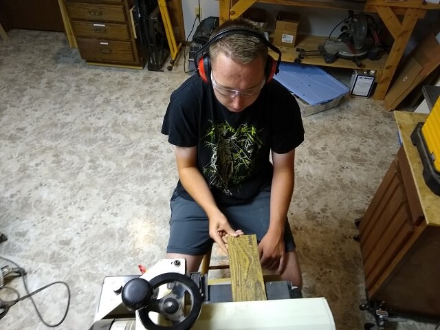 Sanding the cavity cover material to thickness.