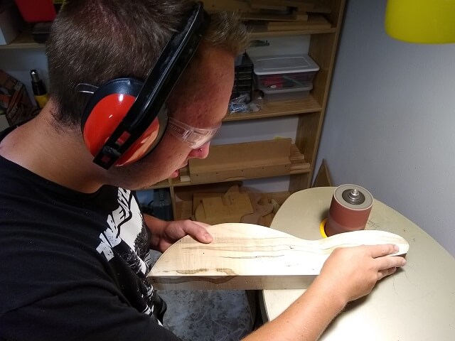Sanding the body wings to shape.