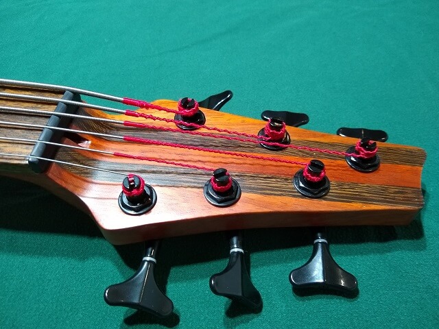 A closeup of the front right side of the headstock.