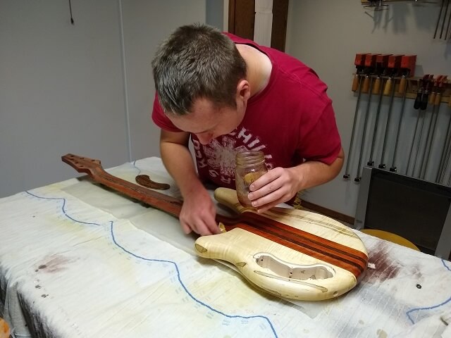 Putting shellac on the back of the bass.