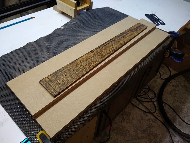 The fretboard attached to the radius jig table.