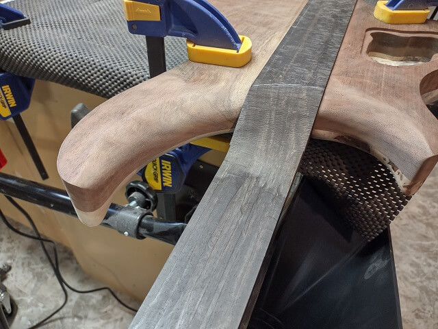 The rough carved neck heel.