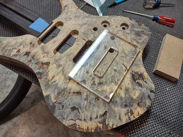 Attaching the Floyd Rose bridge routing template.