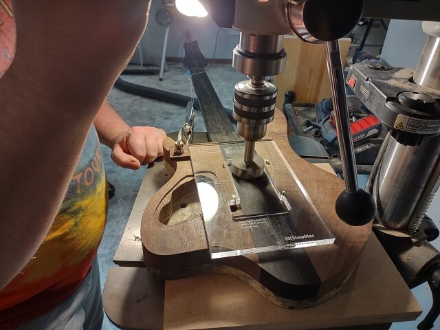 Drilling out the excess wood for the rear spring cavity.