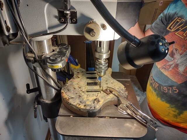 Drilling the post holes for the Floyd Rose bridge.