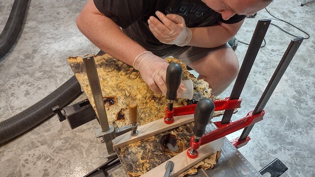 Filling other holes in the buckeye burl with the epoxy resin..