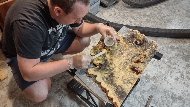 Filling other holes in the buckeye burl with the epoxy resin..