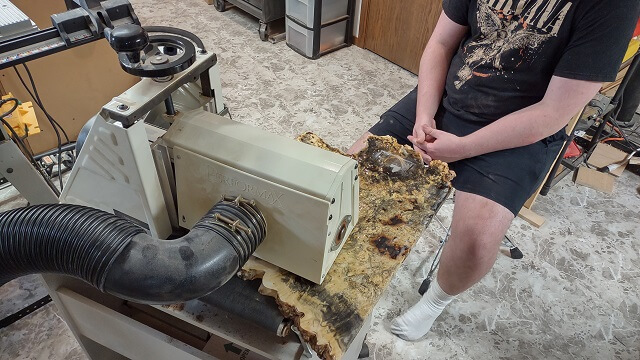 Using the drum sander to sand the buckeye burl smooth after the holes were filled with resin.