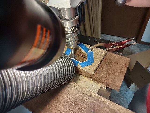 Drilling out the excess wood from the control cavity.