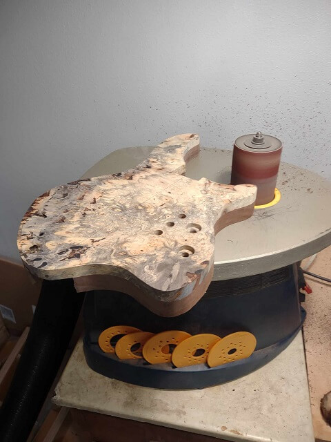 Sanding the body to the exact size with the oscillating spindle sander.