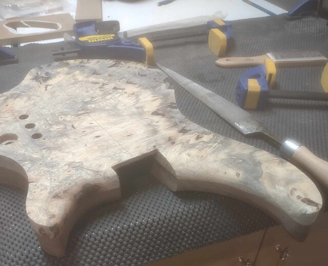 The completed carve of the inner upper horns on the top of the guitar.