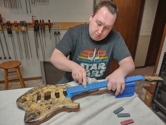 Removing the scratches from the frets.