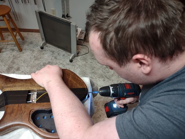 Drilling the holes for the strap screws.