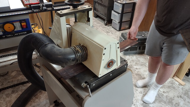 Sanding the rosewood fretboard to thickness.