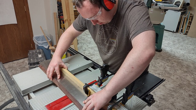 Cutting the fret slots in the fretboard.