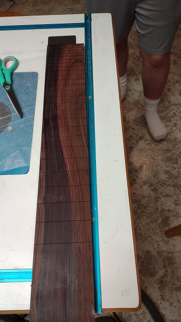 The fret slots cut in the fretboard blank.