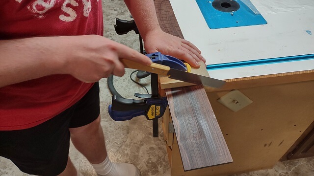 Trimming the nut end of the fretboard.