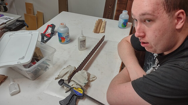 Gluing down the fret ends.