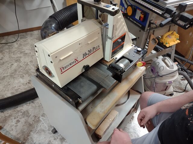 Sanding the face of the headstock smooth on the drum sander.