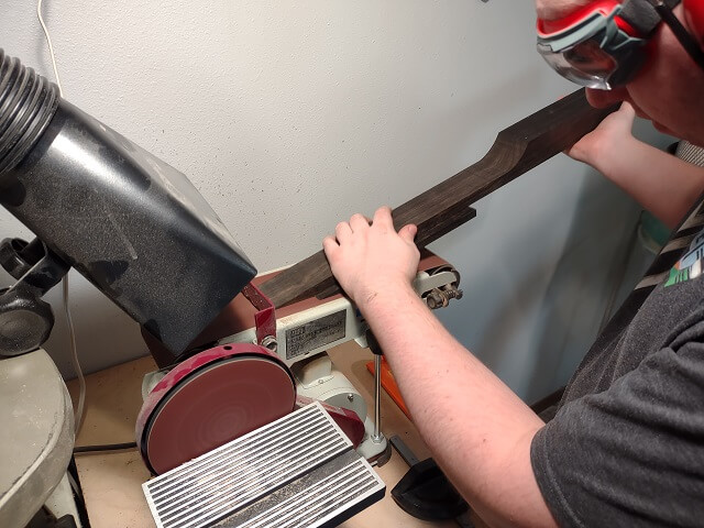 Sanding the two pieces of the scarf joint smooth.