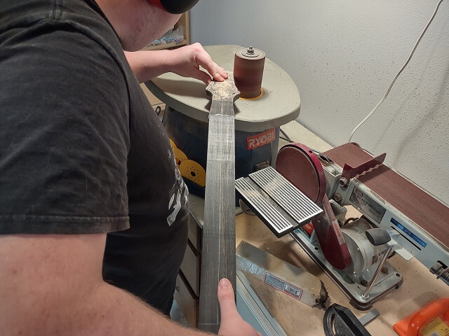 Sanding the headstock to exact shape.