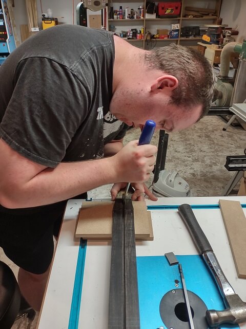 Enlarging the upper portion of the truss rod route for the adjustment barrel.