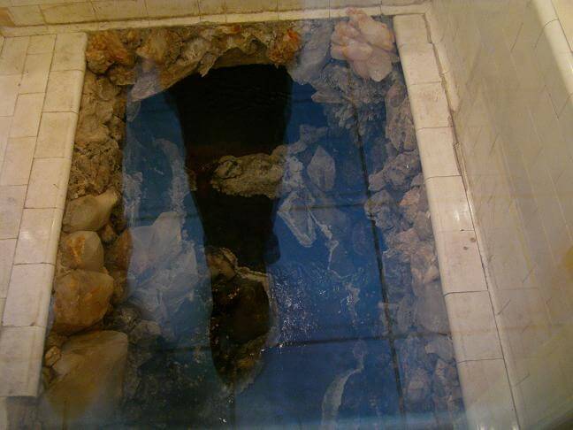 The opening to the natural spring that fed the bathhouse.