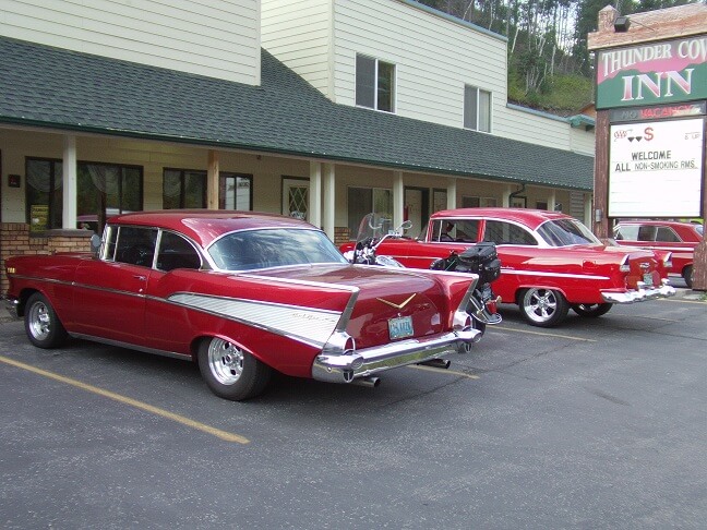A couple of beautiful old Chevy cars parked outside the hotel.