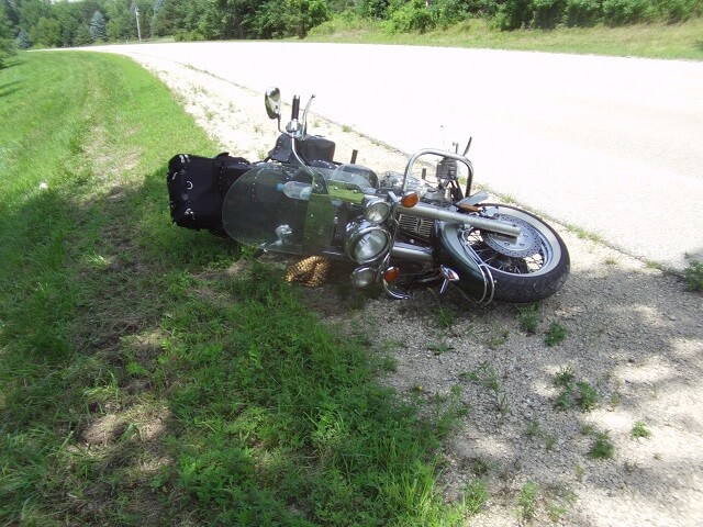 My motorcycle laying on the ground after hitting some loose gravel.