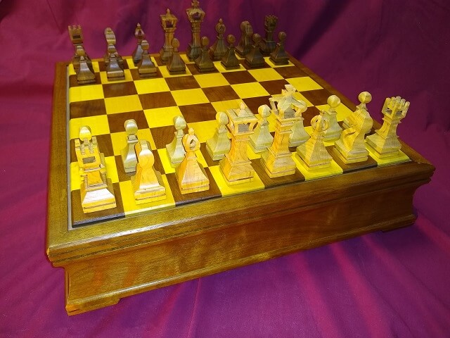 The completed chess pieces, sitting on the chess board I built.