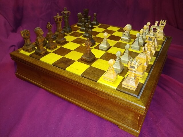 The completed chess pieces, sitting on the chess board I built.
