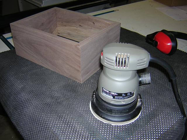 Sanding the box sides after the glue dried.